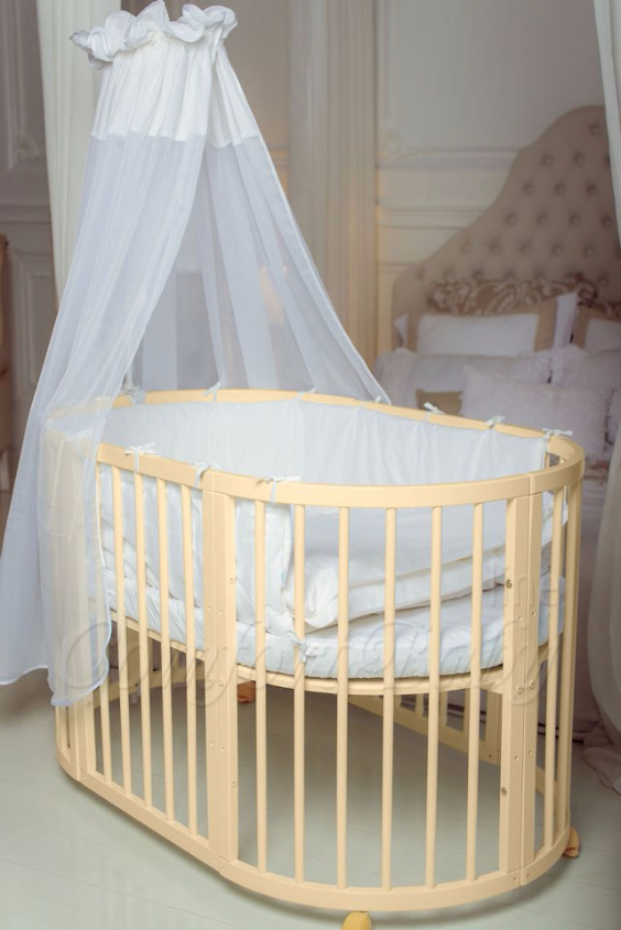 КРОВАТКА- ТРАНСФОРМЕР "COMFORT BABY" .Цена: 25 000 руб.  ХАРАКТЕРИСТИКИ:  возраст детей: 0-5 лет  габариты модели (Д х Ш х В): 1) колыбельки: 78*76*81 см  2) овальной кроватки: 128*76*81 cм  матрас приобретается отдельно.  максимальная нагрузка: 120 кг  Материал: изготавливается только из настоящего массива бука высшего сорта.  сборка: кровать в разобранном виде, простота сборки, инструкция по сборке на русском языке  продукция сертифицирована  производство: Россия  гарантия: 2 года   Дополнительные характеристики: 4 положения по высоте (расстояние положения дна от пола без колес: 1см, 12см, 37см, 57см; расстояние между отверстиями снизу-наверх: 12см, 15см, 20см.); 3 прутика - съемные.  КОНМПЛЕКТАЦИЯ:  1-я ступень - круглая кроватка  2-я ступень - овальная кроватка  3-я ступень - диванчик  4-я ступень - манеж  5-я и 6-я ступени - 2 кресла и столик  7-я ступень - пеленальный столик  ДОПОЛНИТЕЛЬНЫЕ ОПЦИИ:  Комплект постельный "Classic" +6950 руб.  Комплект постельный "Colorit" + 11990 руб.  Фирменный держатель для балдахина +790 руб.  Комплект цельных матрасов " Холкон"/ "Кокос" (круглый+овальный) +8490 руб  Маятник "ComfortBaby Pendulum" 2 в 1+6990 руб.