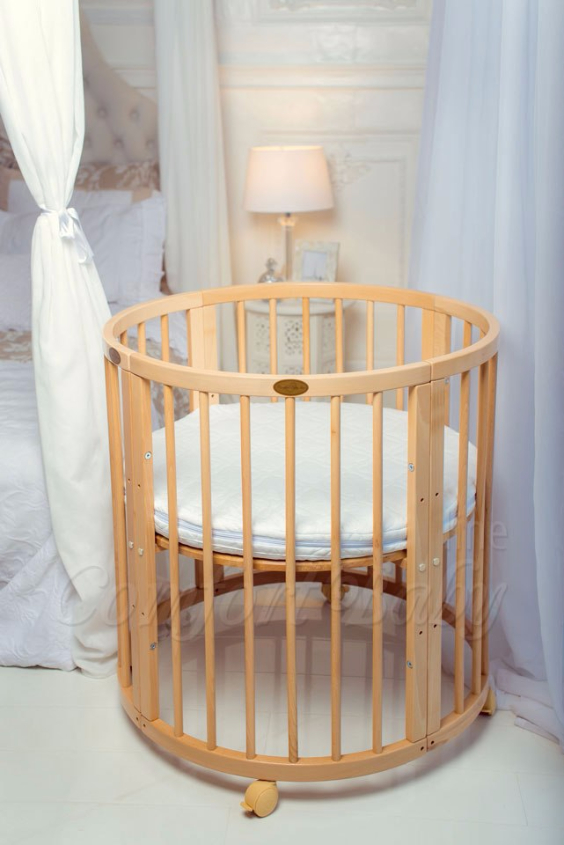 КРОВАТКА- ТРАНСФОРМЕР "COMFORT BABY" .Цена: 25 000 руб.  ХАРАКТЕРИСТИКИ:  возраст детей: 0-5 лет  габариты модели (Д х Ш х В): 1) колыбельки: 78*76*81 см  2) овальной кроватки: 128*76*81 cм  матрас приобретается отдельно.  максимальная нагрузка: 120 кг  Материал: изготавливается только из настоящего массива бука высшего сорта.  сборка: кровать в разобранном виде, простота сборки, инструкция по сборке на русском языке  продукция сертифицирована  производство: Россия  гарантия: 2 года   Дополнительные характеристики: 4 положения по высоте (расстояние положения дна от пола без колес: 1см, 12см, 37см, 57см; расстояние между отверстиями снизу-наверх: 12см, 15см, 20см.); 3 прутика - съемные.  КОНМПЛЕКТАЦИЯ:  1-я ступень - круглая кроватка  2-я ступень - овальная кроватка  3-я ступень - диванчик  4-я ступень - манеж  5-я и 6-я ступени - 2 кресла и столик  7-я ступень - пеленальный столик  ДОПОЛНИТЕЛЬНЫЕ ОПЦИИ:  Комплект постельный "Classic" +6950 руб.  Комплект постельный "Colorit" + 11990 руб.  Фирменный держатель для балдахина +790 руб.  Комплект цельных матрасов " Холкон"/ "Кокос" (круглый+овальный) +8490 руб  Маятник "ComfortBaby Pendulum" 2 в 1+6990 руб.
