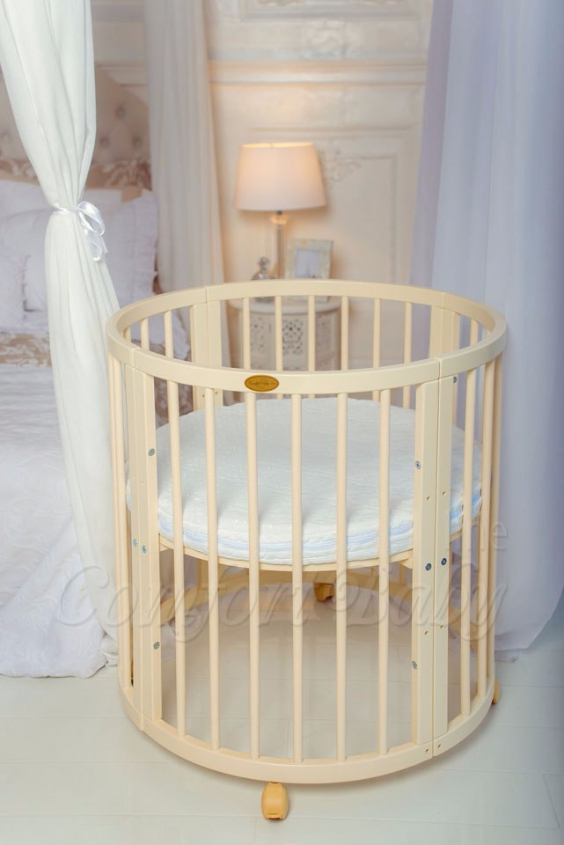 КРОВАТКА- ТРАНСФОРМЕР "COMFORT BABY" .Цена: 25 000 руб.  ХАРАКТЕРИСТИКИ:  возраст детей: 0-5 лет  габариты модели (Д х Ш х В): 1) колыбельки: 78*76*81 см  2) овальной кроватки: 128*76*81 cм  матрас приобретается отдельно.  максимальная нагрузка: 120 кг  Материал: изготавливается только из настоящего массива бука высшего сорта.  сборка: кровать в разобранном виде, простота сборки, инструкция по сборке на русском языке  продукция сертифицирована  производство: Россия  гарантия: 2 года   Дополнительные характеристики: 4 положения по высоте (расстояние положения дна от пола без колес: 1см, 12см, 37см, 57см; расстояние между отверстиями снизу-наверх: 12см, 15см, 20см.); 3 прутика - съемные.  КОНМПЛЕКТАЦИЯ:  1-я ступень - круглая кроватка  2-я ступень - овальная кроватка  3-я ступень - диванчик  4-я ступень - манеж  5-я и 6-я ступени - 2 кресла и столик  7-я ступень - пеленальный столик  ДОПОЛНИТЕЛЬНЫЕ ОПЦИИ:  Комплект постельный "Classic" +6950 руб.  Комплект постельный "Colorit" + 11990 руб.  Фирменный держатель для балдахина +790 руб.  Комплект цельных матрасов " Холкон"/ "Кокос" (круглый+овальный) +8490 руб  Маятник "ComfortBaby Pendulum" 2 в 1+6990 руб.