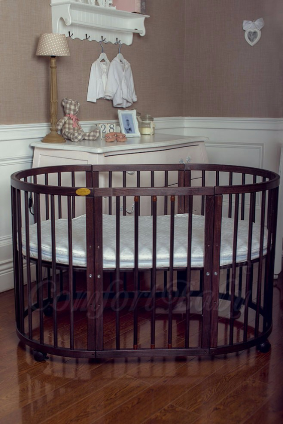 КРОВАТКА- ТРАНСФОРМЕР "COMFORT BABY" .Цена: 25 000 руб.  ХАРАКТЕРИСТИКИ:  возраст детей: 0-5 лет  габариты модели (Д х Ш х В): 1) колыбельки: 78*76*81 см  2) овальной кроватки: 128*76*81 cм  матрас приобретается отдельно.  максимальная нагрузка: 120 кг  Материал: изготавливается только из настоящего массива бука высшего сорта.  сборка: кровать в разобранном виде, простота сборки, инструкция по сборке на русском языке  продукция сертифицирована  производство: Россия  гарантия: 2 года   Дополнительные характеристики: 4 положения по высоте (расстояние положения дна от пола без колес: 1см, 12см, 37см, 57см; расстояние между отверстиями снизу-наверх: 12см, 15см, 20см.); 3 прутика - съемные.  КОНМПЛЕКТАЦИЯ:  1-я ступень - круглая кроватка  2-я ступень - овальная кроватка  3-я ступень - диванчик  4-я ступень - манеж  5-я и 6-я ступени - 2 кресла и столик  7-я ступень - пеленальный столик  ДОПОЛНИТЕЛЬНЫЕ ОПЦИИ:  Комплект постельный "Classic" +6950 руб.  Комплект постельный "Colorit" + 11990 руб.  Фирменный держатель для балдахина +790 руб.  Комплект цельных матрасов " Холкон"/ "Кокос" (круглый+овальный) +8490 руб  Маятник "ComfortBaby Pendulum" 2 в 1+6990 руб.