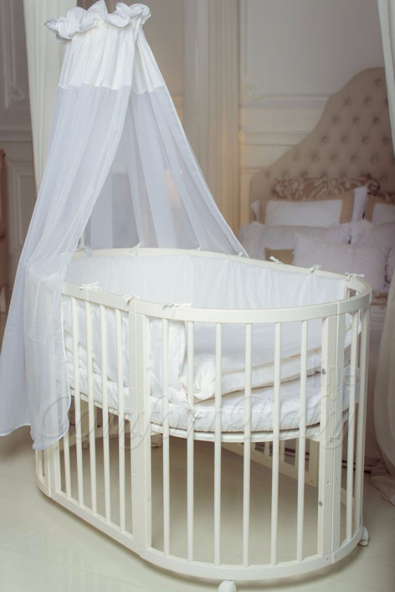 КРОВАТКА- ТРАНСФОРМЕР "COMFORT BABY" .Цена: 25 000 руб.  ХАРАКТЕРИСТИКИ:  возраст детей: 0-5 лет  габариты модели (Д х Ш х В): 1) колыбельки: 78*76*81 см  2) овальной кроватки: 128*76*81 cм  матрас приобретается отдельно.  максимальная нагрузка: 120 кг  Материал: изготавливается только из настоящего массива бука высшего сорта.  сборка: кровать в разобранном виде, простота сборки, инструкция по сборке на русском языке  продукция сертифицирована  производство: Россия  гарантия: 2 года   Дополнительные характеристики: 4 положения по высоте (расстояние положения дна от пола без колес: 1см, 12см, 37см, 57см; расстояние между отверстиями снизу-наверх: 12см, 15см, 20см.); 3 прутика - съемные.  КОНМПЛЕКТАЦИЯ:  1-я ступень - круглая кроватка  2-я ступень - овальная кроватка  3-я ступень - диванчик  4-я ступень - манеж  5-я и 6-я ступени - 2 кресла и столик  7-я ступень - пеленальный столик  ДОПОЛНИТЕЛЬНЫЕ ОПЦИИ:  Комплект постельный "Classic" +6950 руб.  Комплект постельный "Colorit" + 11990 руб.  Фирменный держатель для балдахина +790 руб.  Комплект цельных матрасов " Холкон"/ "Кокос" (круглый+овальный) +8490 руб  Маятник "ComfortBaby Pendulum" 2 в 1+6990 руб.